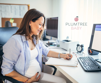 pregnant woman at work reviewing parental leave paperwork