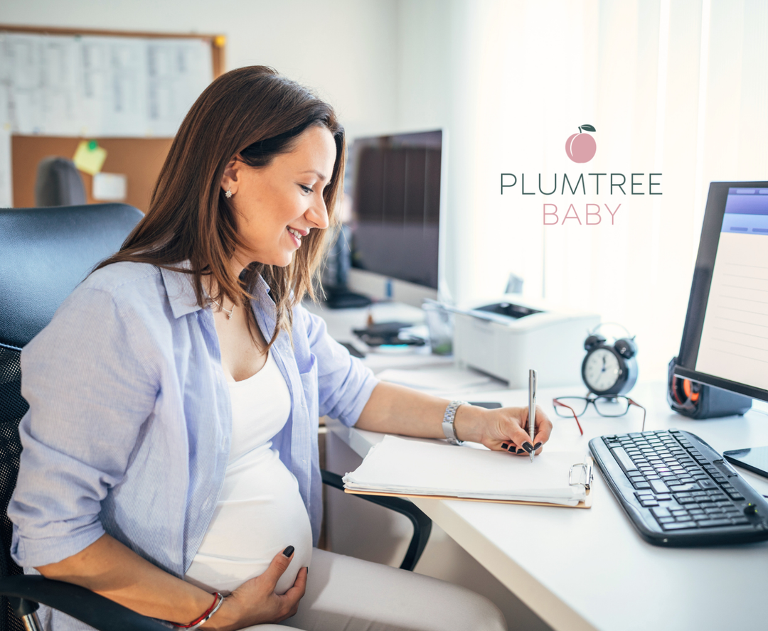 pregnant woman at work reviewing parental leave paperwork