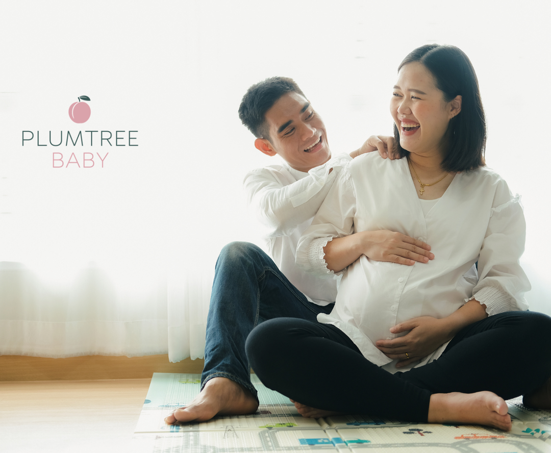 A couple is laughing during early labor while the partner offers a shoulder massage.